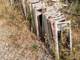 a pile of old wooden chairs sitting on the side of the road