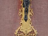 a gold cross with a crucifix on it