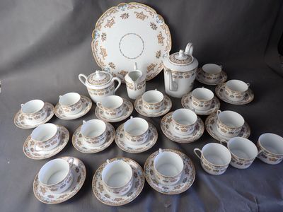 many cups and saucers that are sitting on a table
