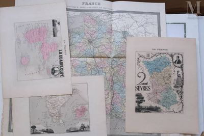 many different maps of the world on a table