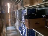 boxes are stacked on a shelf in a warehouse with a lot of shelves