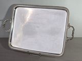 a silver tray with a handle on it on a table