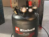 a black air compressor sitting on the floor next to a box