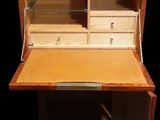 a small wooden desk with a drawer on top of it