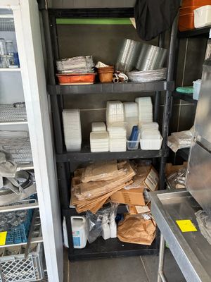 a small kitchen with a lot of items on the shelves