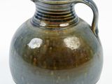 a brown vase with a handle on a white background