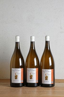 trois bouteilles de vin posées sur une table en bois