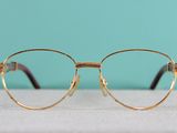 a close up of a pair of glasses sitting on top of a table