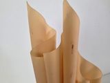 a vase with a bunch of paper in it on a table