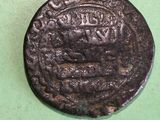 a close up of a coin on a table with a green background