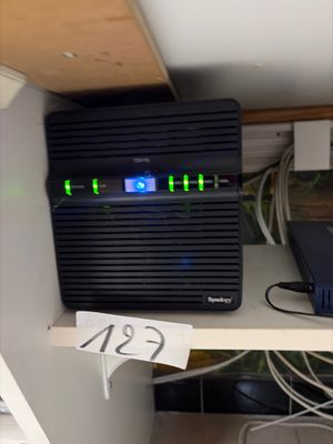 a picture of a computer on a shelf with a lot of wires