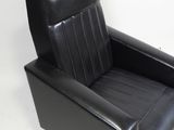 black leather recliner chair on white background with white wall
