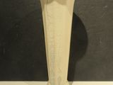 a white vase sitting on a table with a black background