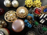 many different types of jewelry on a black surface