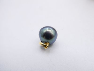 a close up of a black pearl on a white surface