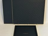 a black box with a gold logo on it and a black box with a gold logo on it