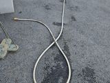a hose attached to the side of a building on the street