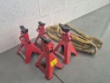 three red jack stands sitting next to each other on the floor