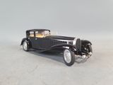 an old model of a black car on a white surface