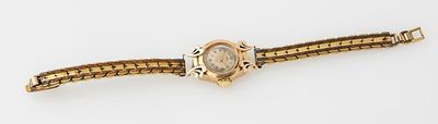 an image of a gold wrist watch with a diamond in the center