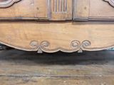 a wooden dresser with a mirror on top of it