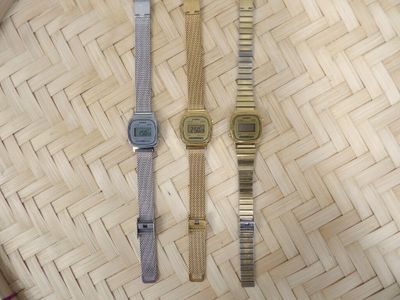 two watches that are sitting on a woven basket