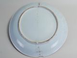 a white plate with a cross on it sitting on a table