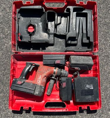 a red tool case with tools in it on the ground