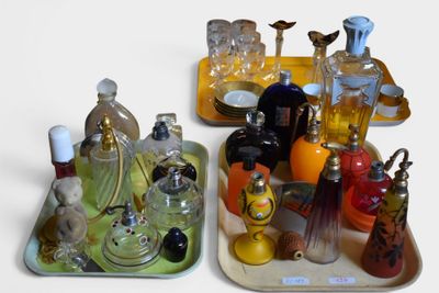 two trays that have different types of perfumes on them