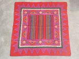 an image of a red table cloth with a colorful design on it