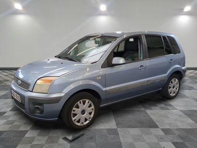 a picture of a small blue car parked in a garage