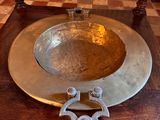 a metal bowl sitting on a wooden table