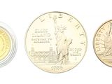 four different coins are shown in a row on a white surface