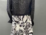 a black and white dress with a floral pattern on the skirt