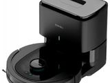 a close up of a black robot on a white surface