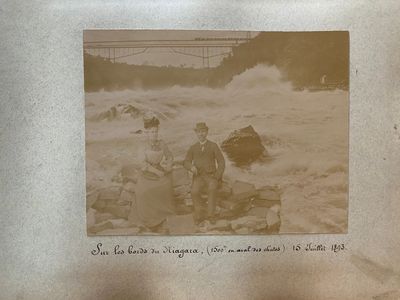 an old photo of two men on the beach