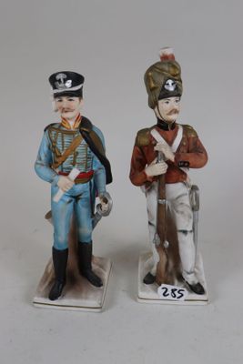 two figurines of men dressed in military uniforms