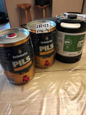 three cans of paint sitting on a table next to a can of paint
