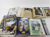 a lot of books and magazines on the table