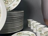 many plates and cups that are sitting on a table
