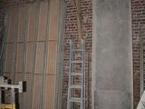 a picture of a room with a ladder and a brick wall