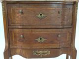 a wooden chest of drawers with a marble top