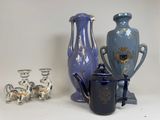 three vases and a teapot sitting on a table