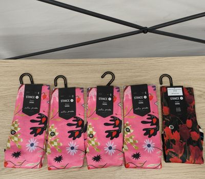 quatre paires de chaussettes roses ornées de fleurs noires et rouges