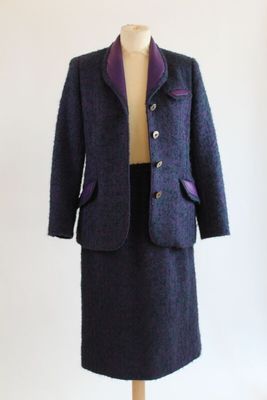 an image of a woman ' s coat and skirt on a mannequin