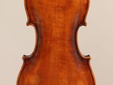 an antique violin with a wooden back and bow