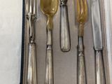 a set of silverware in a case on a table