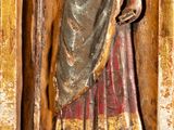 statue of a man holding a staff in a gold frame