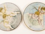 two plates that have angels on them on them