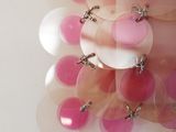a close up of a pink and white cake with pink and white balloons